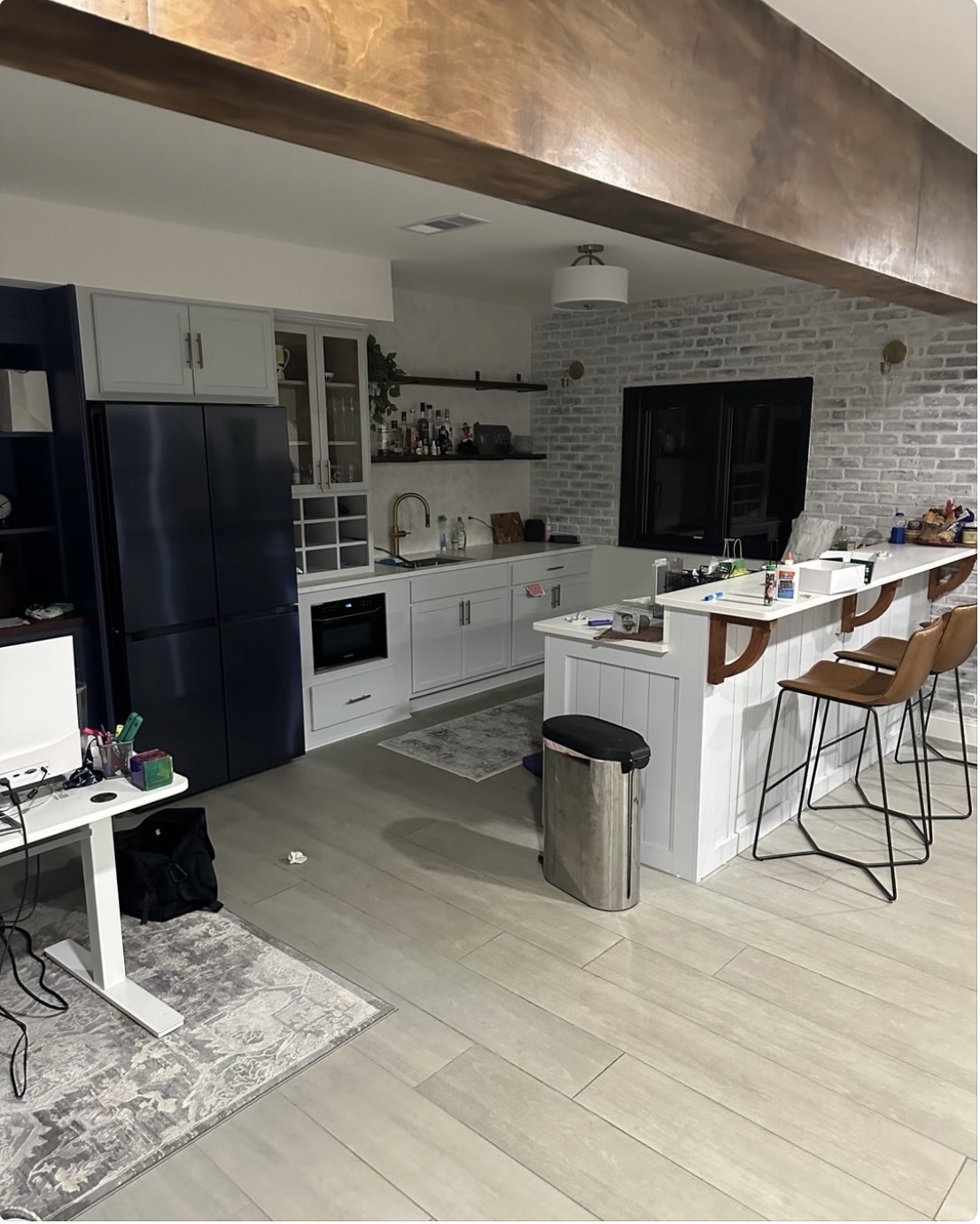 Finished basement kitchen and bar with exposed wood beam
